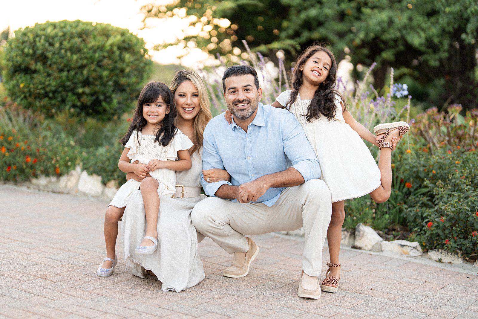 Candid lifestyle portrait of a family laughing together during a golden hour session, captured by a professional family photographer serving Los Angeles and Orange County.